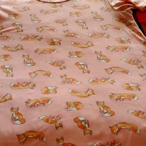 This pretty pink top has orange foxes adorning it. Great casual top.